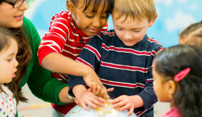 Group of students around a globe