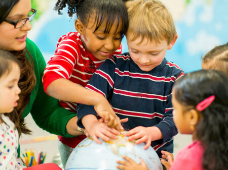 Group of students around a globe