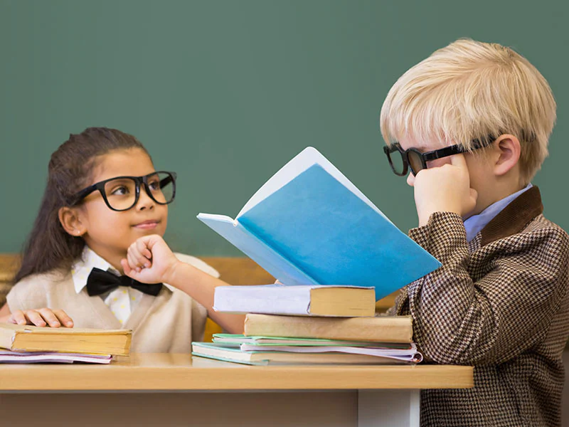 Two children dressed as teachers with glasses